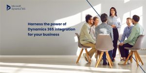 A diverse group of six professionals is seated in a semi-circle, engaged in discussion. They are in a bright, modern office space with large windows. The text on the image reads, "Harness the power of Dynamics 365 integration for your business," along with the Microsoft Dynamics 365 logo.